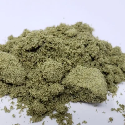 Green herbal powder, likely used for cooking or medicinal purposes, displayed on a white background.