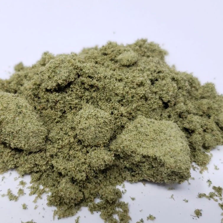 Green herbal powder, likely used for cooking or medicinal purposes, displayed on a white background.
